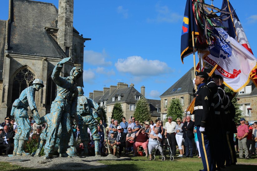 Color Guard Soldiers assigned to the 7th Mission Support Command stand in front of the Four Braves Memorial in Periers, France during the 75th Anniversary of the liberation of the town on July 27, 2019. The 90th Infantry Division, now the 90th Sustainment Brigade, liberated the town during World War II seven weeks after landing on Utah beach just 35 kilometers away. (U.S. Army Reserve Photo by Capt. Joe Bush)