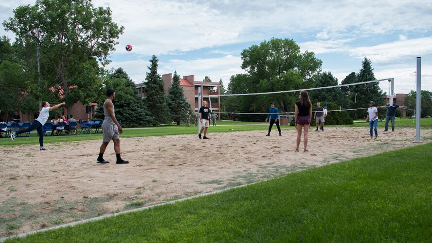 Airmen play volleyball during the inaugural Junior Enlisted Airmen Summer Barbeque at Peterson Air Force Base, Colorado, July 26, 2019. The event aimed to increase morale, build resilience and bring junior enlisted Airmen together. (U.S. Air Force photo by Airman 1st Class Jonathan Whitely)