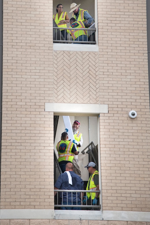 Professionals from the 502nd Air Base Wing Civil Engineer Group work to remediate dorms with mold on Monday, July 29, 2019 and Joint Base San Antonio–Lackland. The mold remediation is taking place after Airmen at JBSA-Lackland voiced their concerns. (U.S. Air Force photo by Sean Worrell)