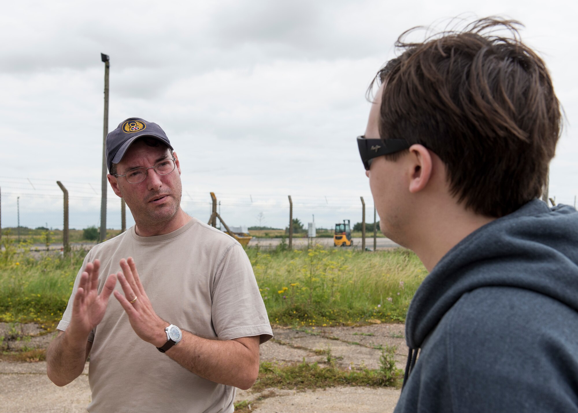 Paul George Bellamy, Airfield Research Group director of archives and collections, explains to Christopher Klimovitz the historical significance of this location on the former flight line near the Alconbury Airfield Heritage Collection, England, July 14, 2019. In the 1960’s and 1970’s this location was used as a Photographic Processing and Interpretation Facility for processing reconnaissance photos gathered from RF4C Phantom aircrafts. (U.S. Air Force photo by Airman 1st Class Jennifer Zima)