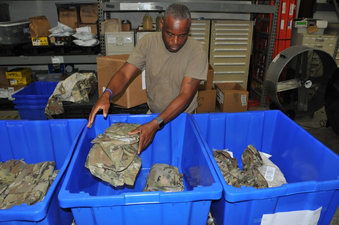 Senior Master Sgt. Anthony Brown, 403rd Logisitics Readiness Squadron logistics supply manager, separates the new Operational Camouflage Pattern uniforms by size in order to fill uniform orders as required. The new uniforms will be mandatory wear by April 1, 2021, with deploying members being the first to receive the uniform. (U.S. Air Force photo by Jessica L. Kendziorek)