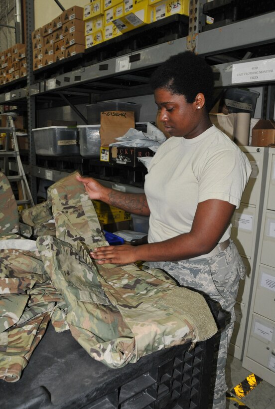 Airman Basic Damaja Prince, 403rd LRS supply apprentice, folds and separates the new Operational Camouflage Pattern uniforms by size in order to fill uniform orders as required. The new uniforms will be mandatory wear by April 1, 2021, with deploying members being the first to receive the uniform. (U.S. Air Force photo by Jessica L. Kendziorek)