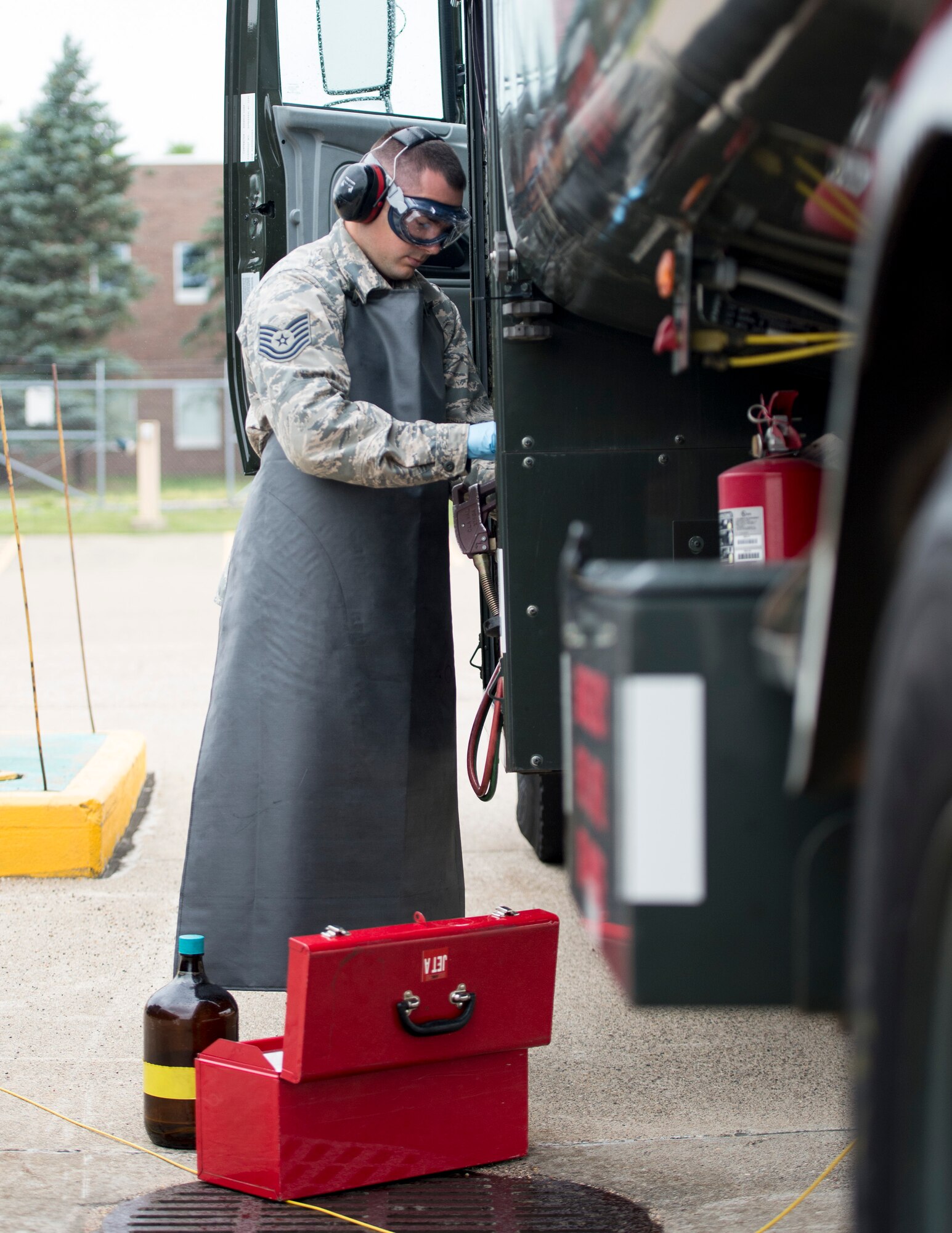 U.S. Air Force Tech. Sgt. Dustin Legatt, a fuels specialist with the 133rd Petroleum, Oil and Lubricants Flight, draws a fuel sample for a quality control test in St. Paul, Minn., July 10, 2019.