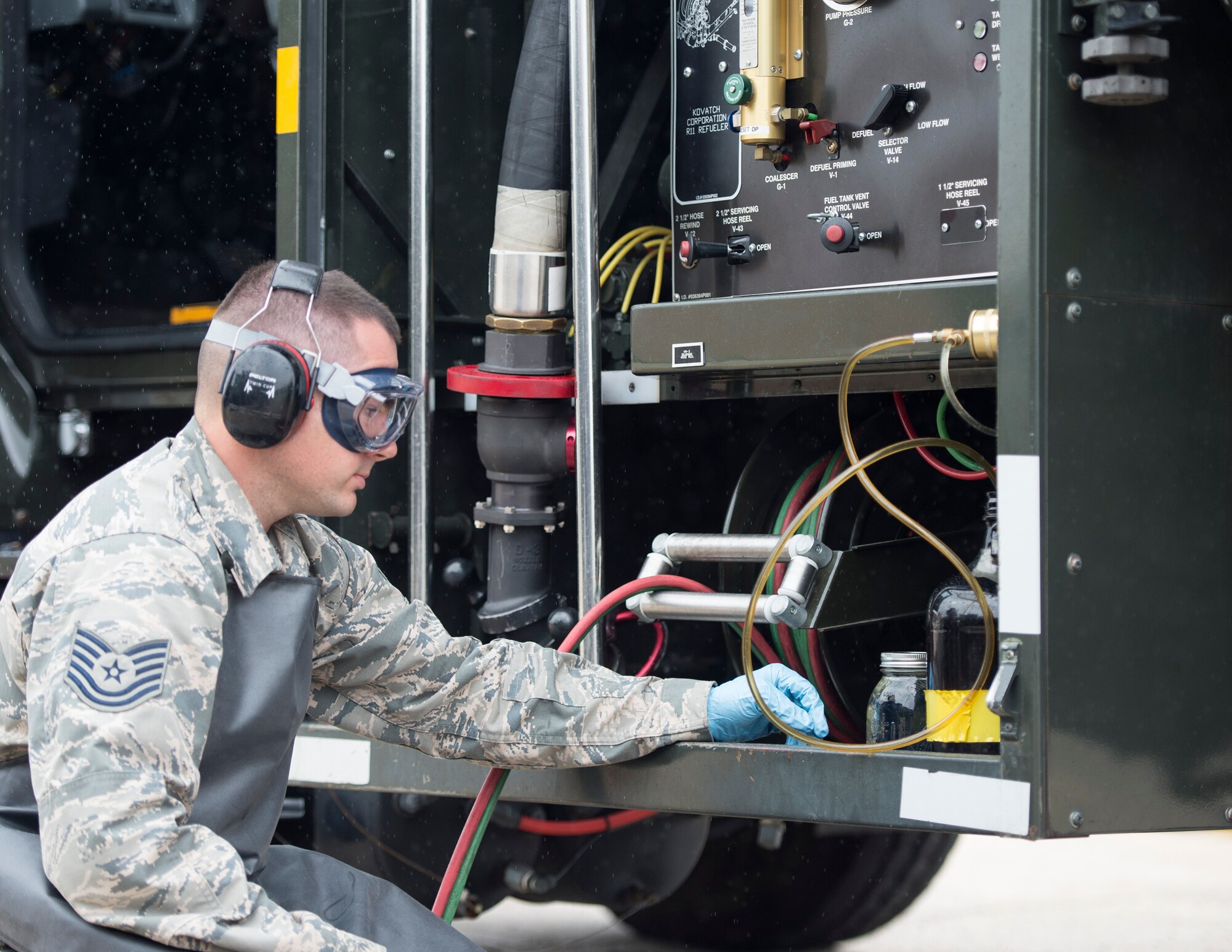 U.S. Air Force Tech. Sgt. Dustin Legatt, a fuels specialist with the 133rd Petroleum, Oil and Lubricants Flight, monitors the quality control of the in-line sampler in St. Paul, Minn., July 10, 2019.