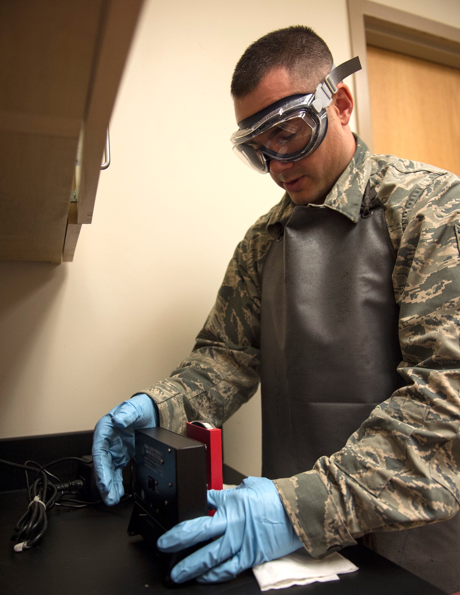 U.S. Air Force Tech. Sgt. Dustin Legatt, a fuels specialist with the 133rd Petroleum, Oil and Lubricants Flight, reads the result from the free water sample within the JET-A fuel in St. Paul, Minn., July 10, 2019.