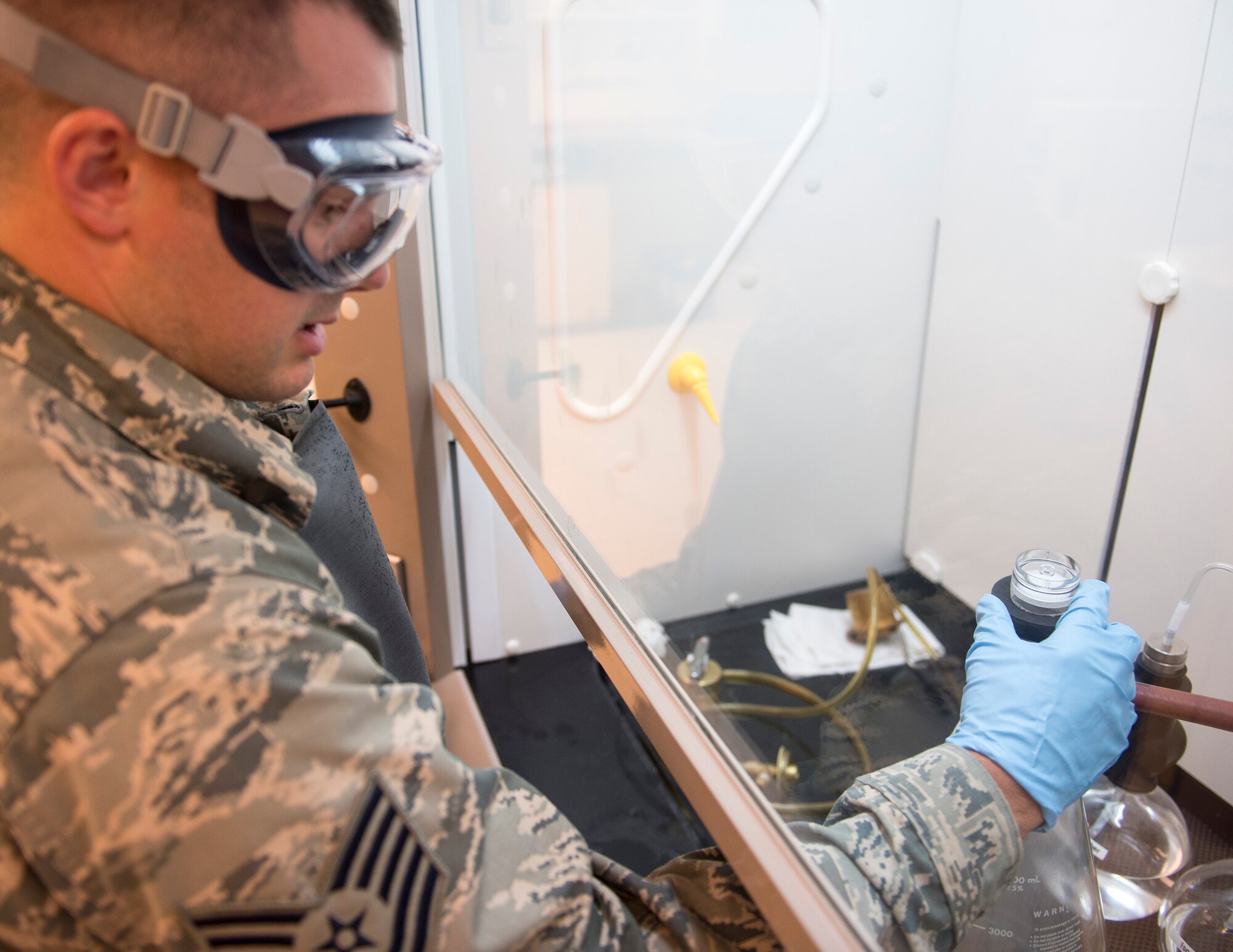 U.S. Air Force Tech. Sgt. Dustin Legatt, a fuels specialist with the 133rd Petroleum, Oil and Lubricants Flight, removes residual from JET-A fuel from the filter monitor in St. Paul, Minn., July 10, 2019.