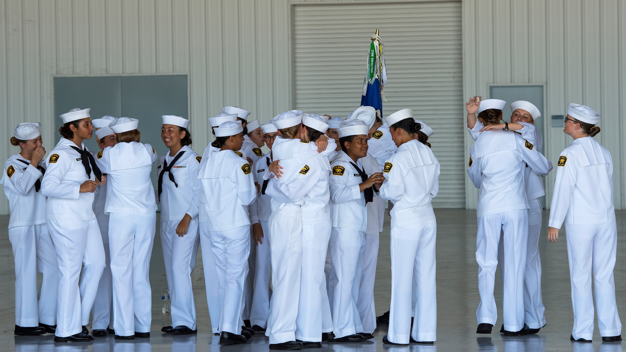 Members of the U.S. Naval Sea Cadet Corps (USNSCC) recruit training flight 1902 celebrate after a graduation ceremony, July 20, 2019, at MacDill Air Force Base, Fla.  The USNSCC recruits received 106 hours of instruction, which focused on the Navy’s core values of honor, courage and commitment. (U.S. Air Force photo by Airman 1st Class Shannon Bowman)