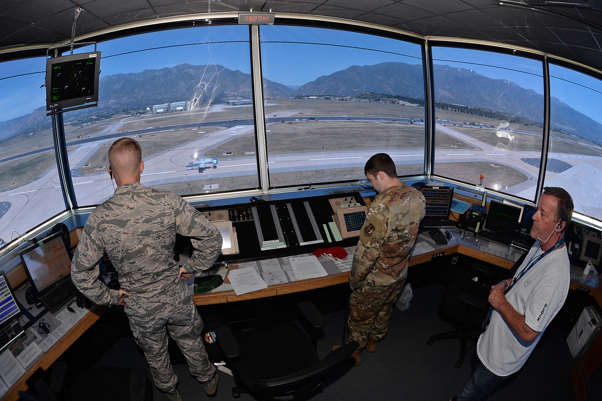 75th Operations Squadron air traffic controllers (left to right) Senior Airman Charles Parks, Senior Airman Jonathon Blanks and John Jobst watch closely from the control tower cab as Col. James Doyle, 413th Flight Test Group test pilot, taxis past after landing on taxiway Alpha in an A-10 Thunderbolt II at the end of a functional check flight at Hill Air Force Base, Utah, July 10, 2019.  The runway at Hill AFB was closed for most of the summer, requiring test pilots to temporarily use the taxiway as a runway. (U.S. Air Force photo by Alex R. Lloyd)