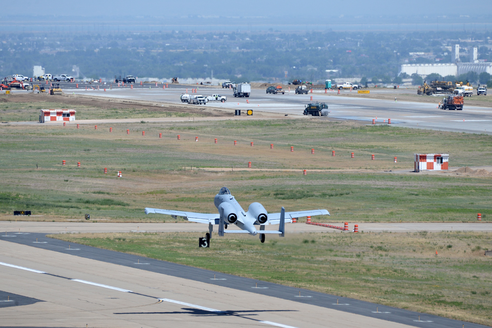 Runway construction efforts can be seen from the control tower as Col. James Doyle, 413th Flight Test Group test pilot, takes off to the north from taxiway Alpha in an A-10 Thunderbolt II at Hill Air Force Base, Utah, July 10, 2019. The runway at Hill AFB was closed for most of the summer, requiring test pilots from the 514th to temporarily use the taxiway as a runway. (U.S. Air Force photo by Alex R. Lloyd)