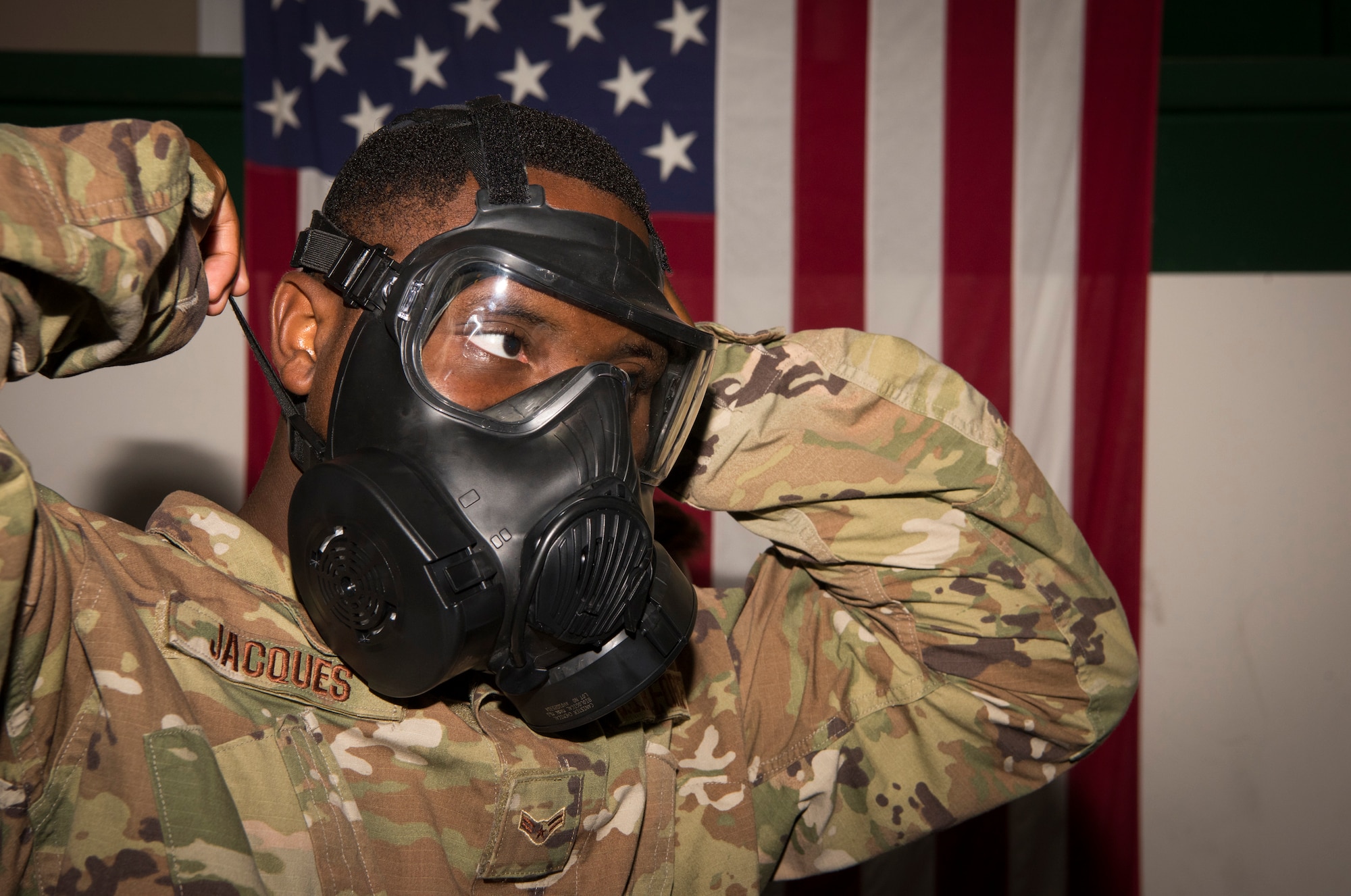 Airman 1st Class Kerson Jacques, a 6th Communications Squadron radio transmission systems technician, puts on a gas mask during deployment readiness training at MacDill Air Force Base, Fla., July 25, 2019.