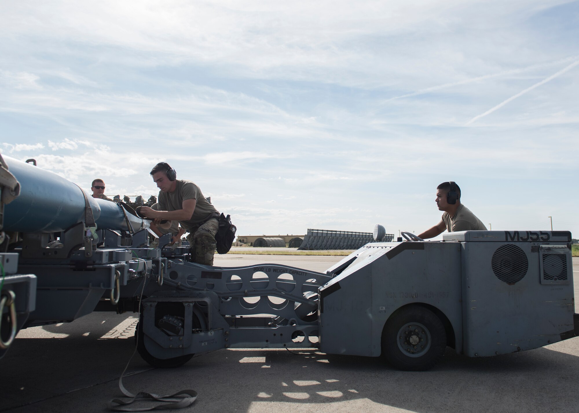 Staff Sgt. Timothy Chouinard, 391st Fighter Squadron, weapopns load crew chief, and Senior Airman Jonathan Castelan Medina, 391st FS, weapons load crew chief, prepare to load training equipment into an F-15E Strike Eagle during the Adaptive Basing exercise July 17, 2019, at Mountain Home Air Force Base. This training was done in order for the fighter squadrons to sharpen their Adaptive Basing strategies, enhancing it's potential down range. (U.S. Air Force photo by Senior Airman Tyrell Hall)