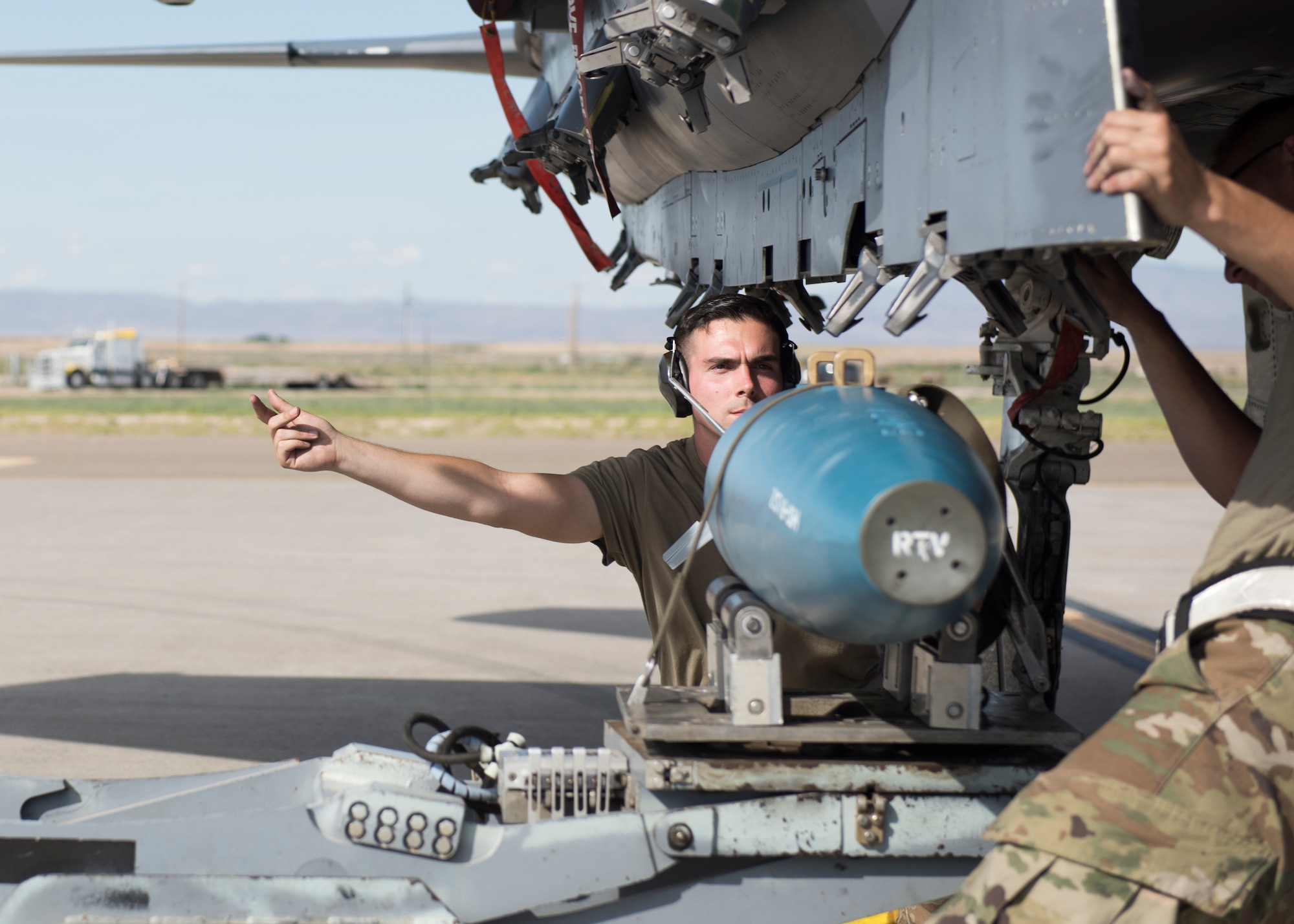 Staff Sgt. Timothy Chouinard, 391st Fighter Squadron, weapopns load crew chief, directs a loading process for an F-15E Strike Eagleduring the Adaptive Basing exercise July 17, 2019, at Mountain Home Air Force Base. This training was done in order for the fighter squadrons to sharpen their Adaptive Basing strategies, enhancing it's potential down range. (U.S. Air Force photo by Senior Airman Tyrell Hall)