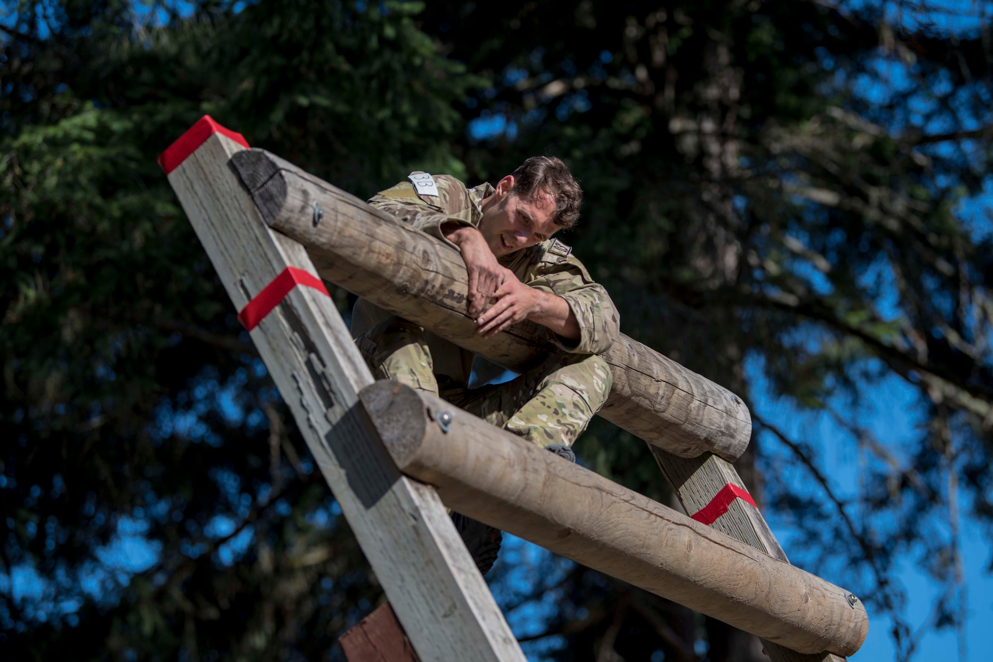 A U.S. Air Force Tactical Air Control Party Airman assigned to the 5th Air Support Operations Squadron, Joint Base Lewis-McChord (JBLM), Wash., climbs on top of an obstacle during the 2019 Lightning Challenge at JBLM, Wash., July 29, 2019.