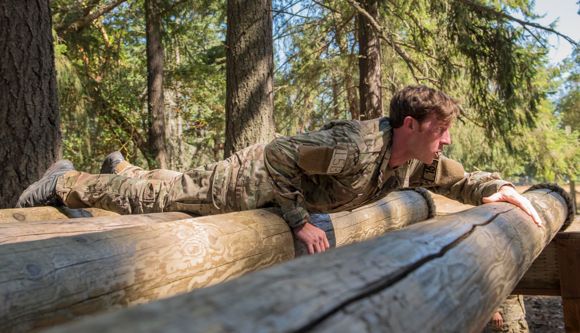 A U.S. Air Force Tactical Air Control Party (TACP) Airman assigned to the 116th Air Support Operations Squadron, Camp Murray, Wash., crawls across rolling logs during the 2019 Lightning Challenge at Joint Base Lewis-McChord, Wash., July 29, 2019.