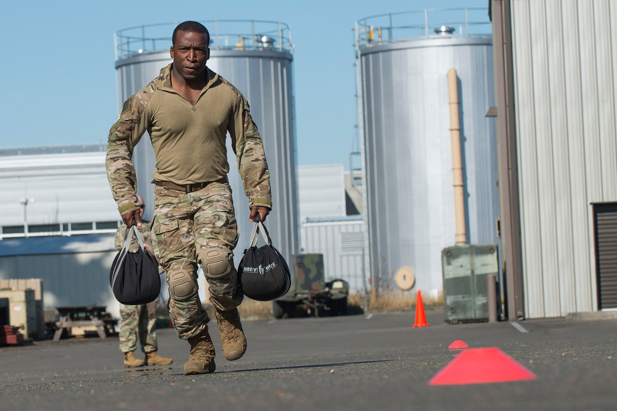 A U.S. Air Force Tactical Air Control Party (TACP) Airman assigned to the 7th Air Support Operations Squadron, Fort Bliss, Texas, runs while carrying weighted bags as part of a Tier II Operator Fitness Test during the 2019 Lightning Challenge at Joint Base Lewis-McChord, Wash., July 29, 2019.