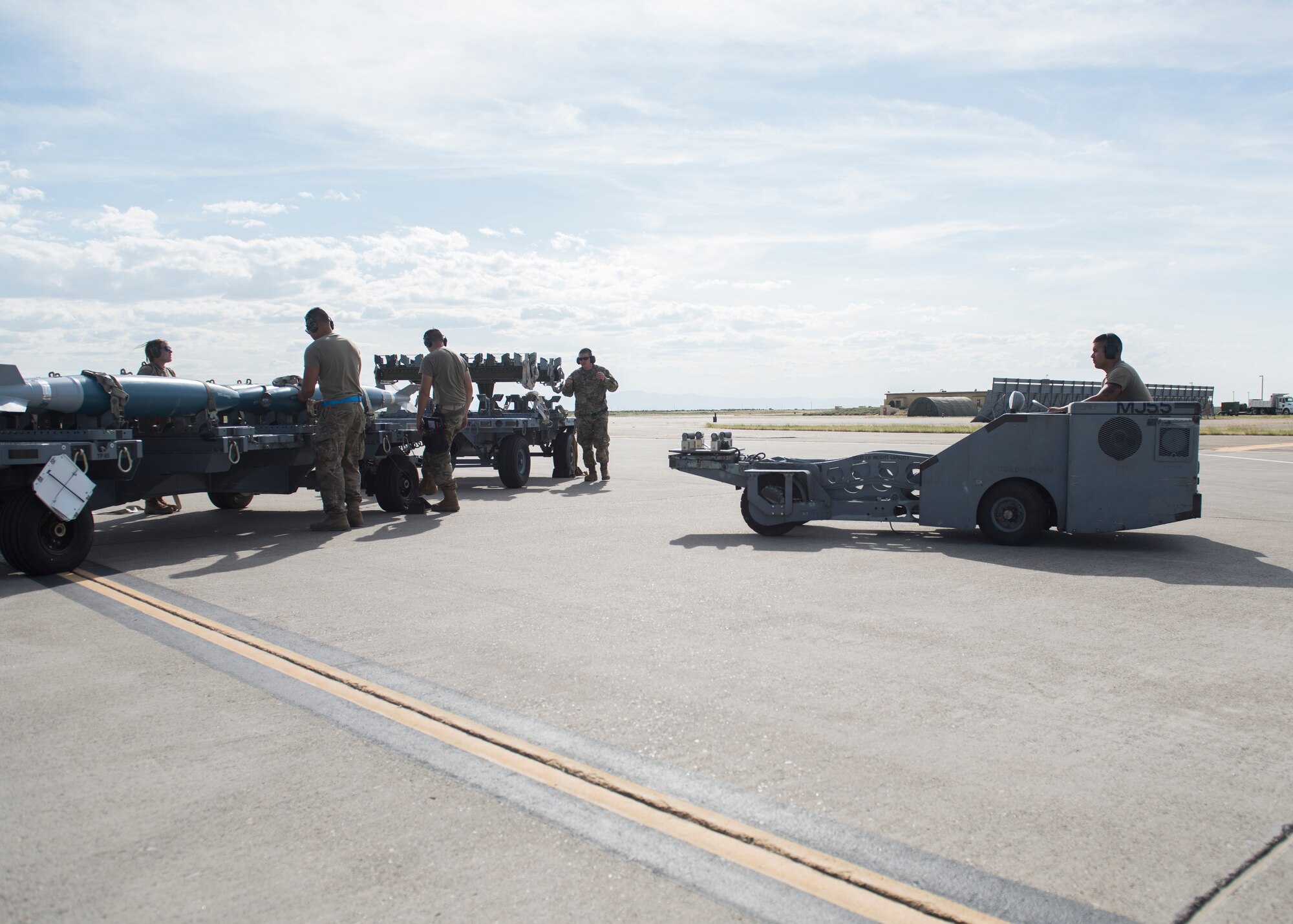 Weapons load crew chiefs from the 391st Fighter squadron prepare to load training eqipment onto an F-15E Strike Eagle during the Adaptive Basing exercise July 17, 2019 at Mountain Home Air Force Base. Weapons load crew chiefs play a vital role in down-range missions, as they are charged with making sure fighter aircraft are re-armed efficiently to continue the fight. (U.S. Air Force photo by Senior Airman Tyrell Hall)