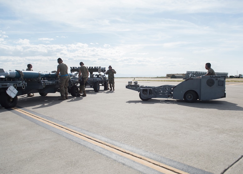 Weapons load crew chiefs from the 391st Fighter squadron prepare to load training eqipment onto an F-15E Strike Eagle during the Adaptive Basing exercise July 17, 2019 at Mountain Home Air Force Base. Weapons load crew chiefs play a vital role in down-range missions, as they are charged with making sure fighter aircraft are re-armed efficiently to continue the fight. (U.S. Air Force photo by Senior Airman Tyrell Hall)