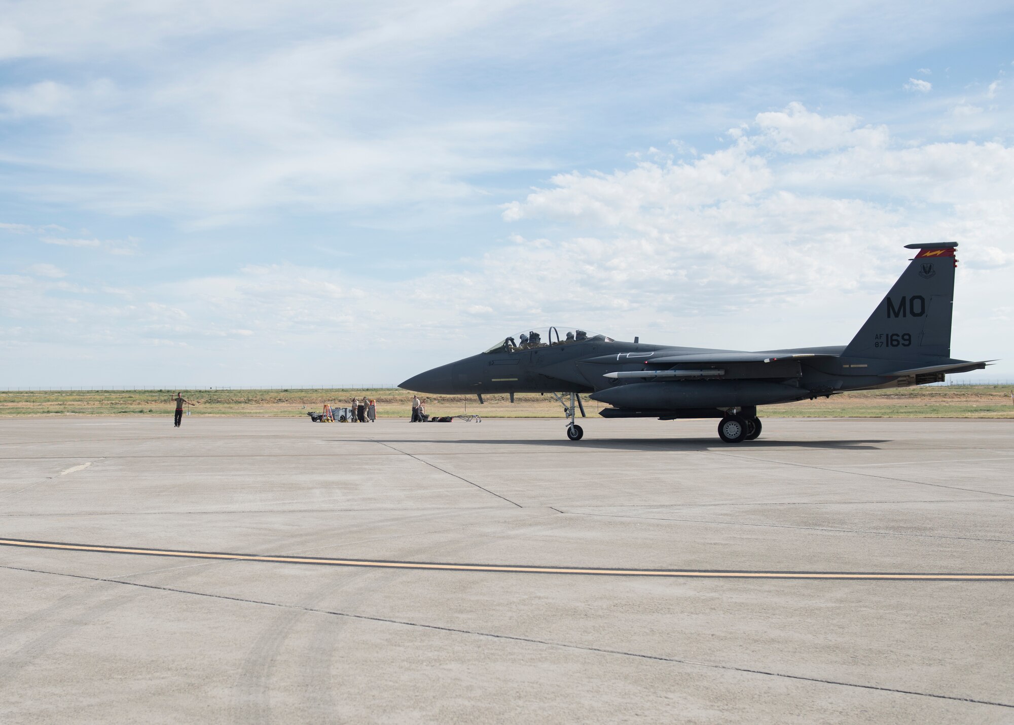 An Airman from the 389th Fighter Squadron directs an F-15E Strike Eagle on an airstrip during the Adaptive Basing exercise July 17, 2019, at Mountain Home Air Force Base. This training was done in order for the fighter squadrons to sharpen their Adaptive Basing strategies, enhancing it's potential down range. (U.S. Air Force photo by Senior Airman Tyrell Hall)