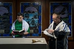 Sailors from Newton, Iowa, read from prayer books during the Rosh Hashanah service in the chapel of the Nimitz-class aircraft carrier USS Ronald Reagan.