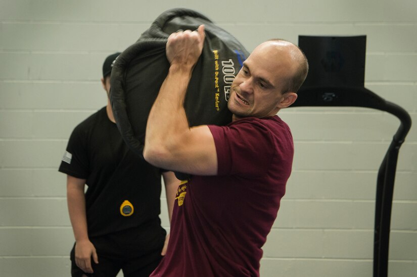 U.S. Air Force 1st Lt. John Novotny, 423rd Mobility Training Squadron deputy flight commander, U.S. Air Force Expeditionary Operations School, Joint Base McGuire-Dix-Lakehurst, N.J., lifts a 100-pound sandbag during the Alpha Warrior Super Regional event July 27, 2019, at Joint Base Charleston, S.C. Twelve Airmen competed, tackling a variety of functional fitness obstacles, while utilizing the Joint Base Charleston Fitness Center’s Alpha Warrior battle rig. The competition focuses on a competitor’s overall readiness and is designed to promote more fit and resilient service members.
