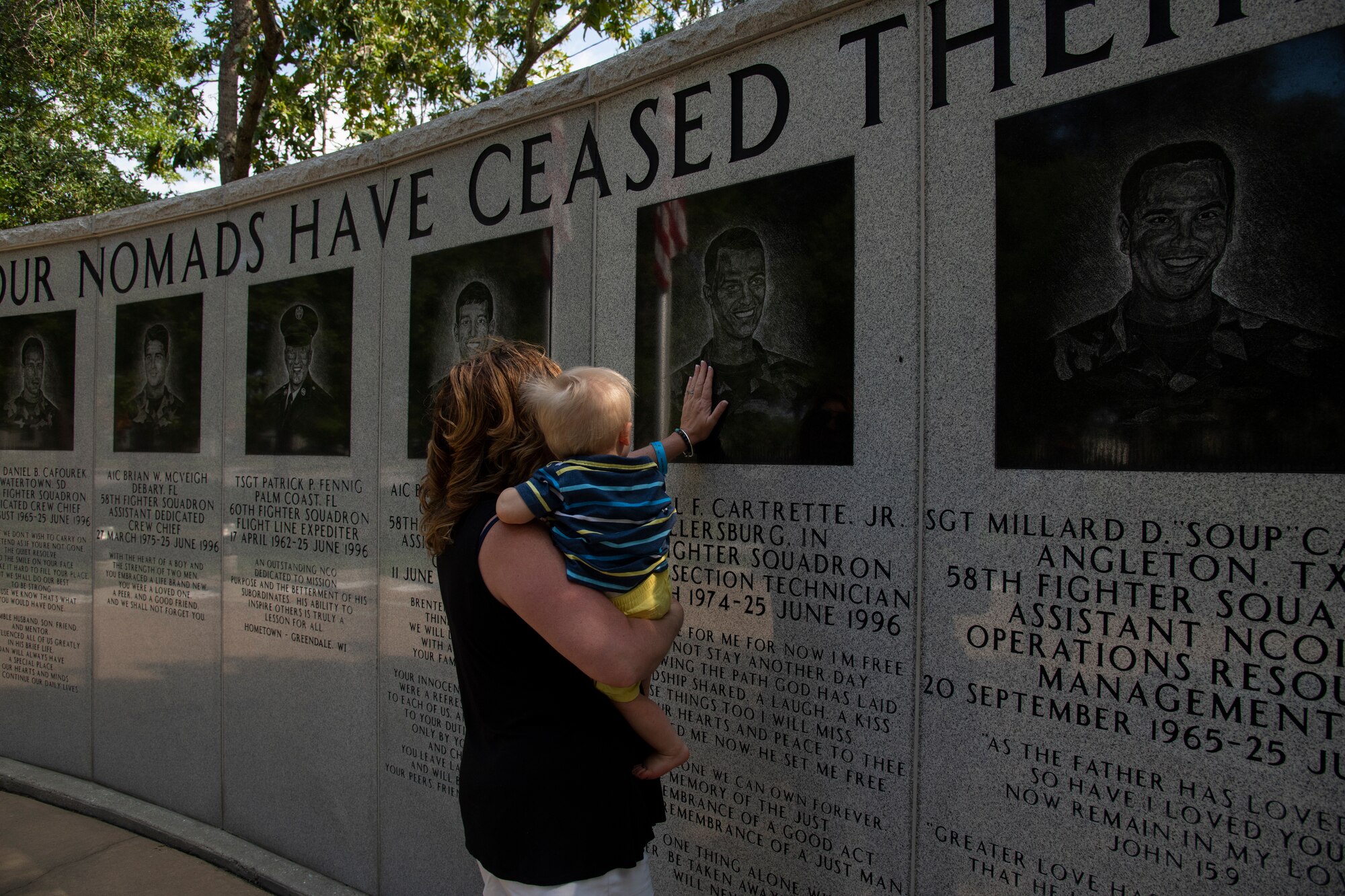 Sally Adams, sister of deceased Senior Airman Earl Cartrette Jr., and child view Cartrette’s memorial for the first time at Eglin Air Force Base, Florida, on July 29, 2019. Adams was adopted when she was two weeks old and spent her life searching for her biological family. Upon finding out her brother had died in the 1996 Khobar Towers attack she and her family made the visit to Eglin to see the memorial. (U.S. Air Force photo by Senior Airman Cassidy Woody)