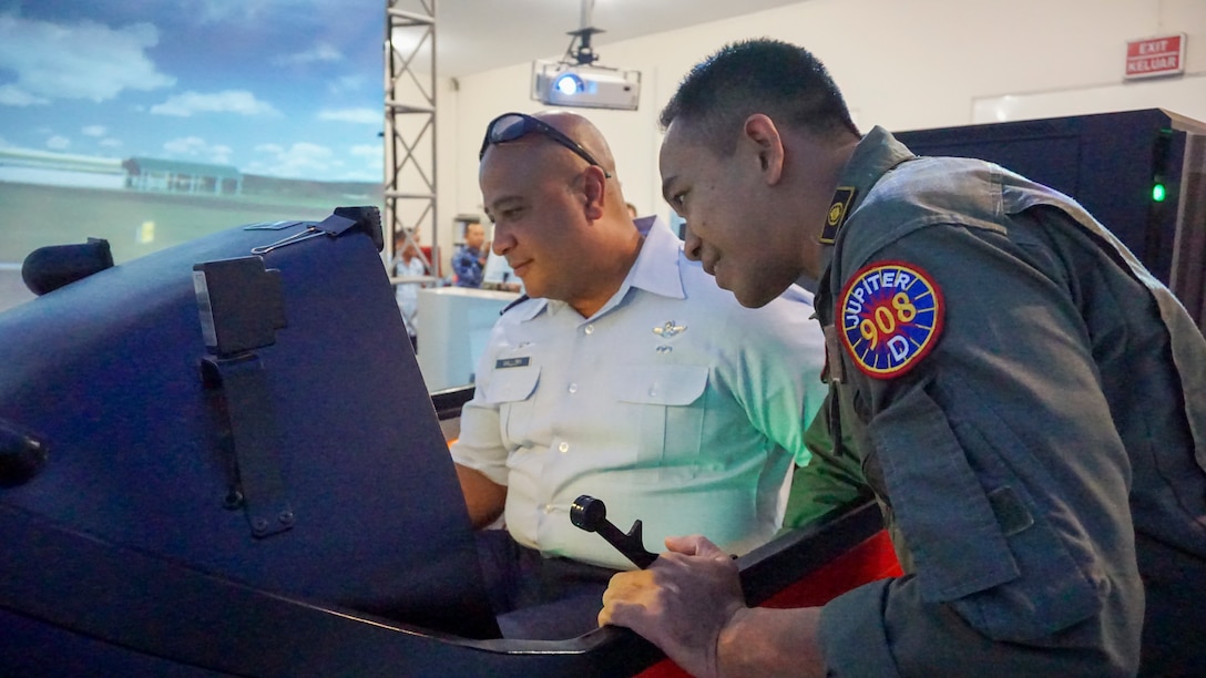 Hawaii Air National Guardsman (HIANG) Colonel Phillip L. Mallory, commander, 298th Air Defense Group (ADG), speaks with a TNI pilot during a tour of the Indonesian Air Force (TNI) Air Training Wing Jul. 10, 2019 in Yogyakarta, Indonesia.