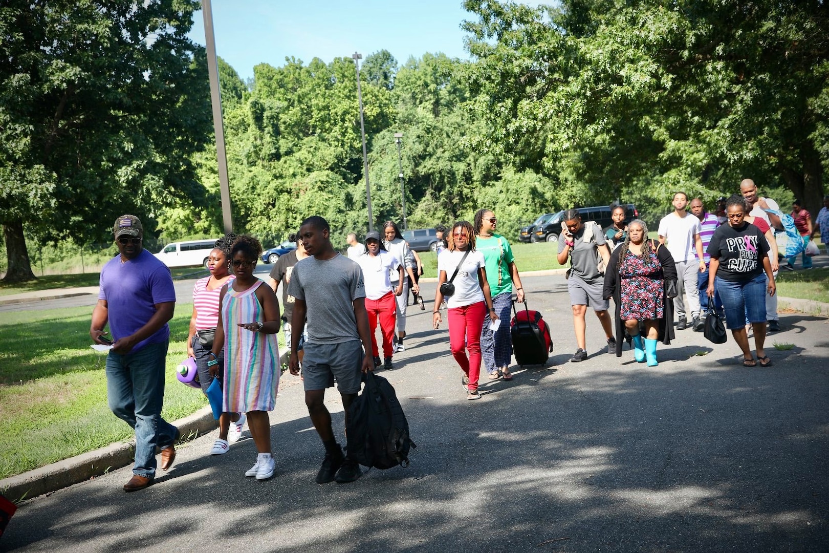 Capital Guardian Youth ChalleNGe Academy participants and families walk to the in-processing area for the military-style program July 13. The CGYCA is a military-style, life intervention, dropout reintegration as well as GED preparatory program open to youths who are between 16-18 years old. (U.S. Army National Guard photo by Sgt. 1st Class Ron Lee)