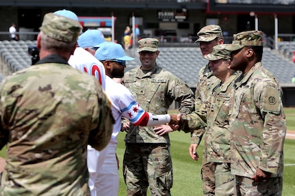 Army Reserve Soldiers assigned to the 85th U.S. Army Reserve Support Command headquarters meet players from the American Association of Independent Professional Baseball’s Chicago Dogs baseball team, July 28, 2019, at Impact Field in Rosemont, Illinois during a home game there against the Cleburne Railroaders.