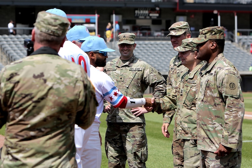 Army Reserve Soldiers assigned to the 85th U.S. Army Reserve Support Command headquarters meet players from the American Association of Independent Professional Baseball’s Chicago Dogs baseball team, July 28, 2019, at Impact Field in Rosemont, Illinois during a home game there against the Cleburne Railroaders.