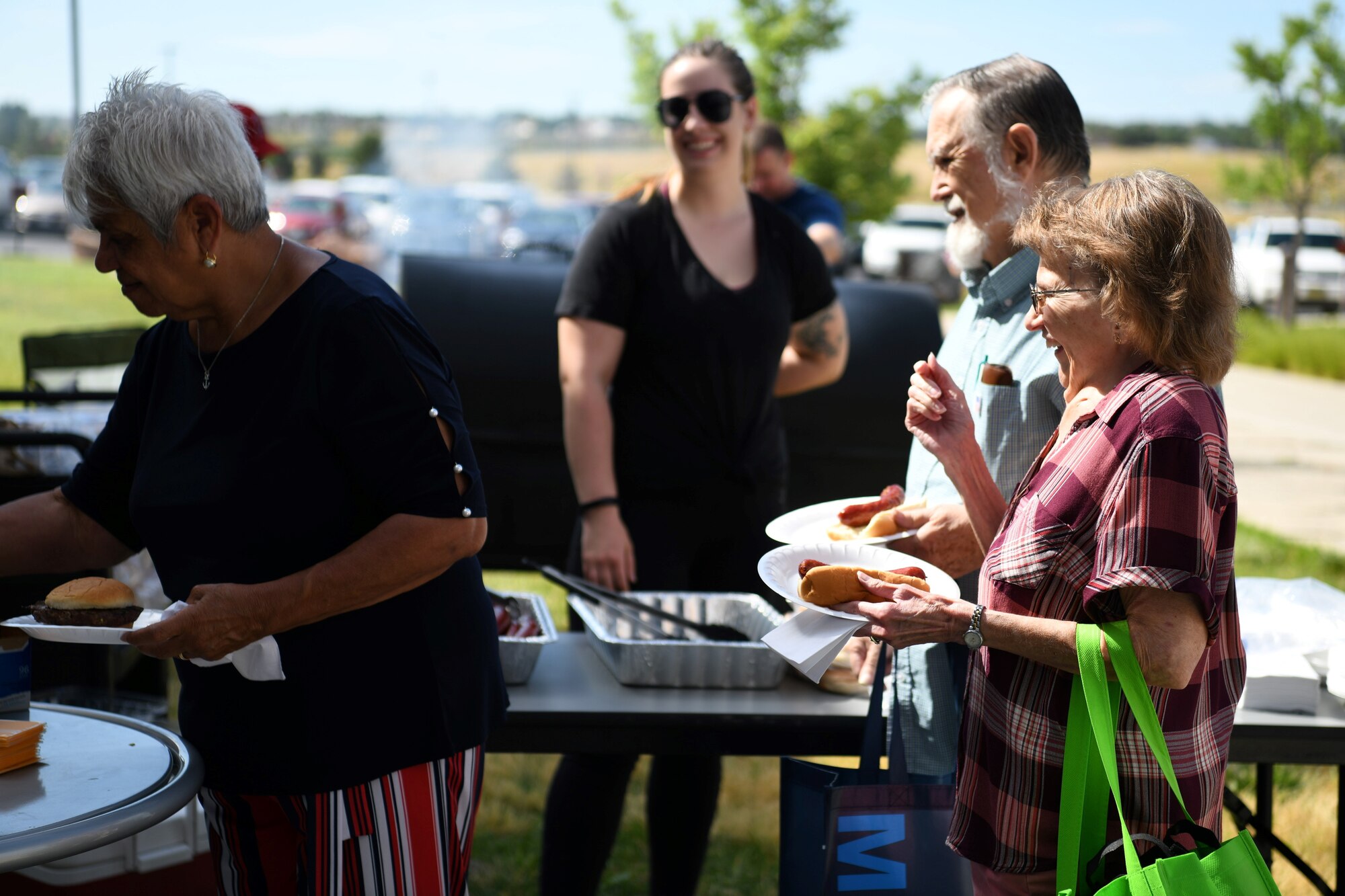 Attendees at the Retiree Appreciation Day stand in line for food, July 27, 2019, on Buckley Air Force Base, Colo. The Retiree Affairs Office hosted Retiree Appreciation Day, giving attendees free food and educating retirees on the free resources available for all their needs and benefits. (U.S. Air Force photo by Airman 1st Class Michael D. Mathews)