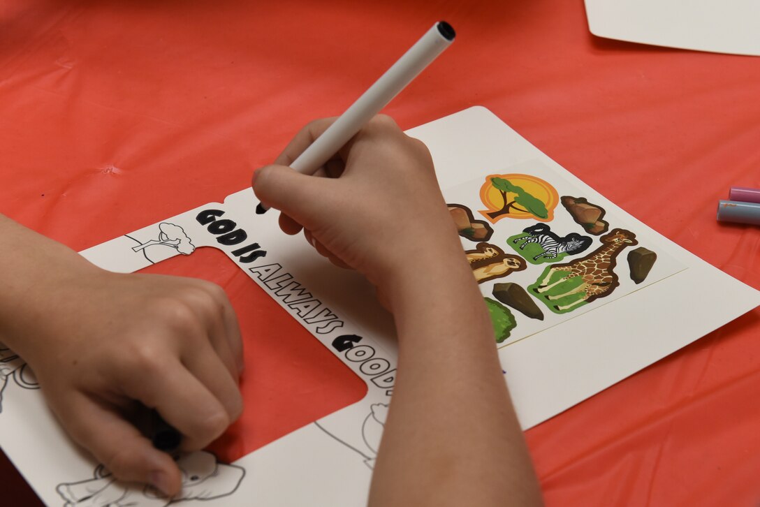 A child colors at Vacation Bible School at the Chapel Community Center at Ellsworth Air Force Base, S.D., July 21, 2019. The Chaplain Corps, in partnership with a youth group from the Immanuel Christian Reformed Church from Orange City, Iowa, hosted the weeklong event for children to play and learn lessons about faith and the struggles they may face in life. (U.S. Air Force photo by Airman Quentin K. Marx)