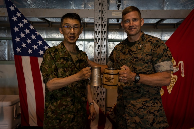 Japanese Ground Self-Defense Force Col. Yutaka Nakajima, commanding officer of Takigahara Garrison, and U.S. Marine Corps Col. Michael D. Reilly, commanding officer of Combined Arms Training Center, Camp Fuji, pose for a photo during a Mess Night July 22, 2019 at Camp Fuji, Japan. The event was put together to a stronger alliance through a U.S. Marine Corps tradition. (U.S. Marine Corps photo by Lance Cpl. Brennan J. Beauton)