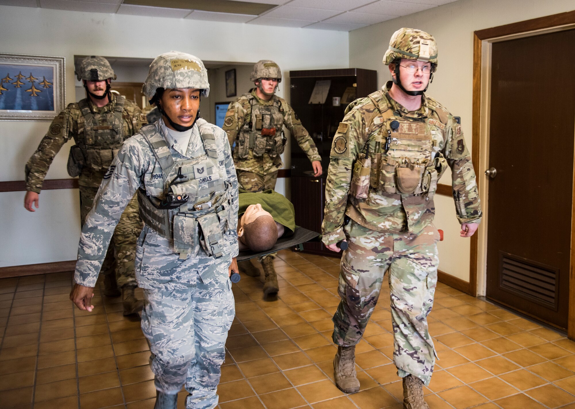 Members of the 8th Security Forces Squadron carry a simulated victim during an exercise at Kunsan Air Base, Republic of Korea, July 23, 2019. Once alerted, 8th SFS responded with precision to a simulated active shooter call, neutralized the simulated threat and secured the area.  (U.S. Air Force photo by Senior Airman Stefan Alvarez)