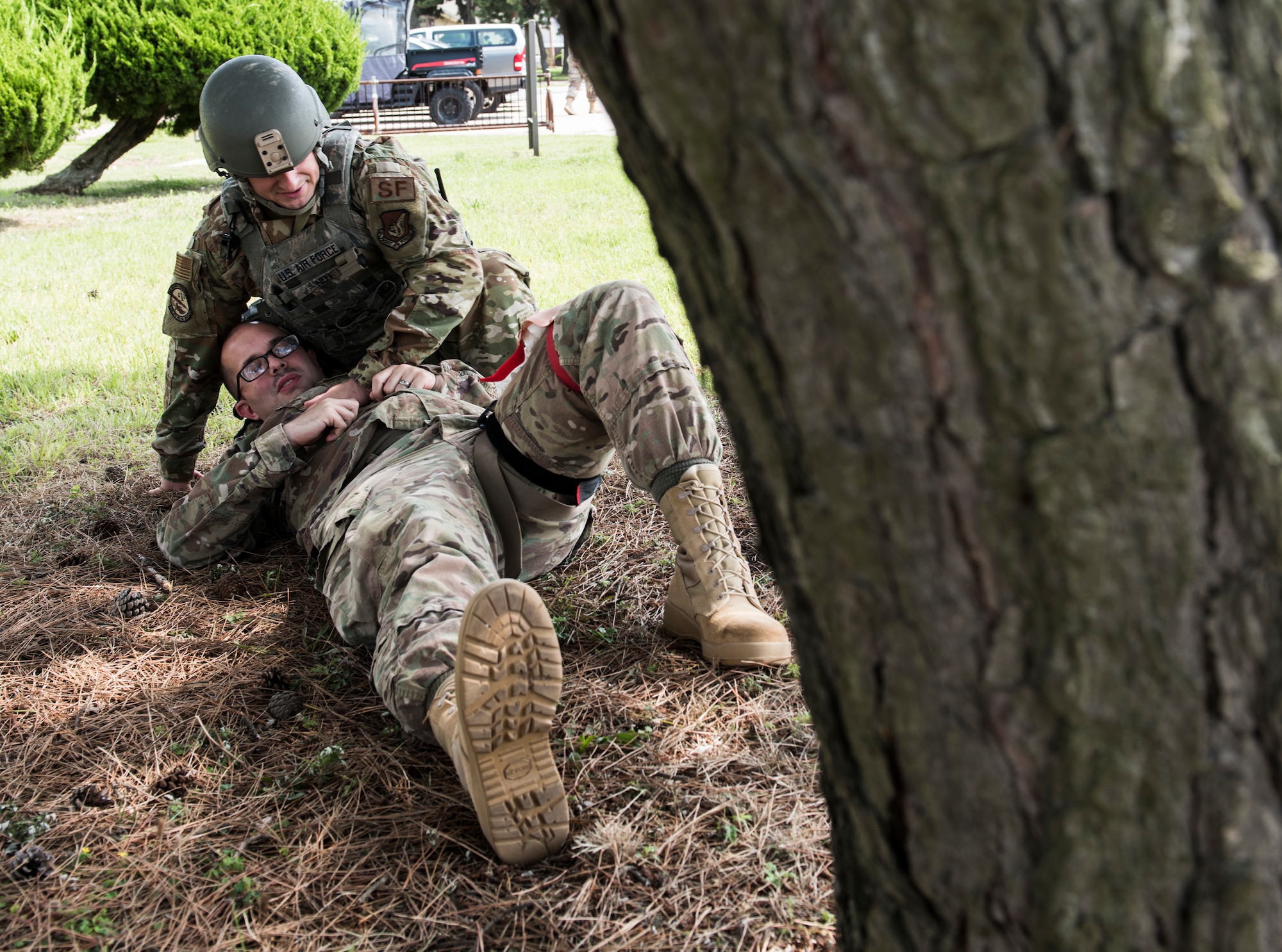 U.S. Air Force Staff Sgt. Bryce Neff, 8th Security Forces Squadron member, comforts a simulated victim during an exercise at Kunsan Air Base, Republic of Korea, July 23, 2019. Once alerted, 8th SFS responded with precision to a simulated active shooter call, neutralized the simulated threat and secured the area.  (U.S. Air Force photo by Senior Airman Stefan Alvarez)