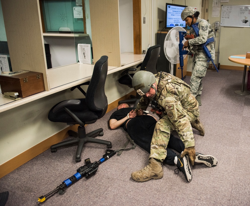 U.S. Air Force Staff Sgt. Brandan Eck (left), and Tech. Sgt. Ashlin Thomas (right), 8th Security Forces Squadron members, search a simulated active shooter during an exercise at Kunsan Air Base, Republic of Korea, July 23, 2019. 8th SFS routinely trains to respond to a variety of threats. (U.S. Air Force photo by Senior Airman Stefan Alvarez)