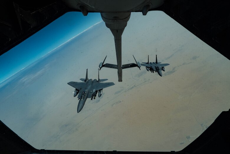 Two F-15E Strike Eagles assigned to the 336th Expeditionary Fighter Squadron approach a KC-10 Extender for refueling June 27, 2019, at an undisclosed location during a surface combat air patrol mission over the Arabian Gulf. The various munitions configurations provide the jets with diverse response options while conducting combat air patrol missions in support of maritime operations. (U.S. Air Force photo by Staff Sgt. Erin Piazza)