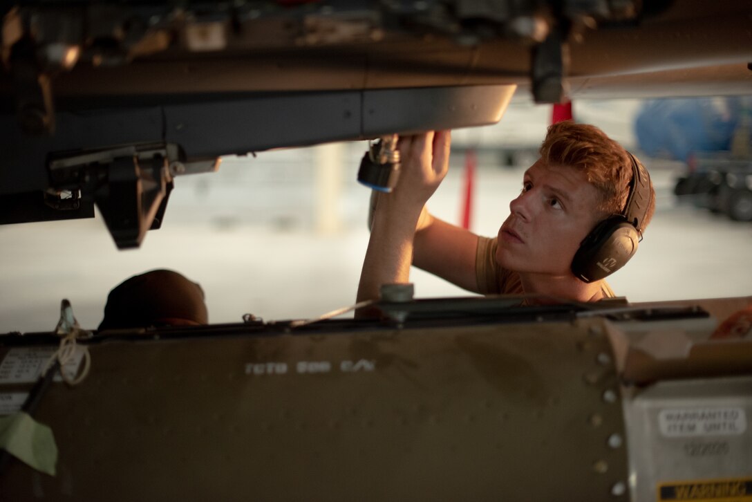 U.S. Air Force Senior Airman Sean Logan, 380th Expeditionary Aircraft Maintenance Squadron weapons load crew team member, adjusts a pylon before attaching a munition to an F-15E Strike Eagle July 15, 2019, at Al Dhafra Air Base, United Arab Emirates. The F-15E is a dual-role fighter designed to perform air-to-air and air-to-ground missions and is currently supporting surface combat air patrol operations in the Arabian Gulf. (U.S. Air Force photo by Staff Sgt. Chris Thornbury)