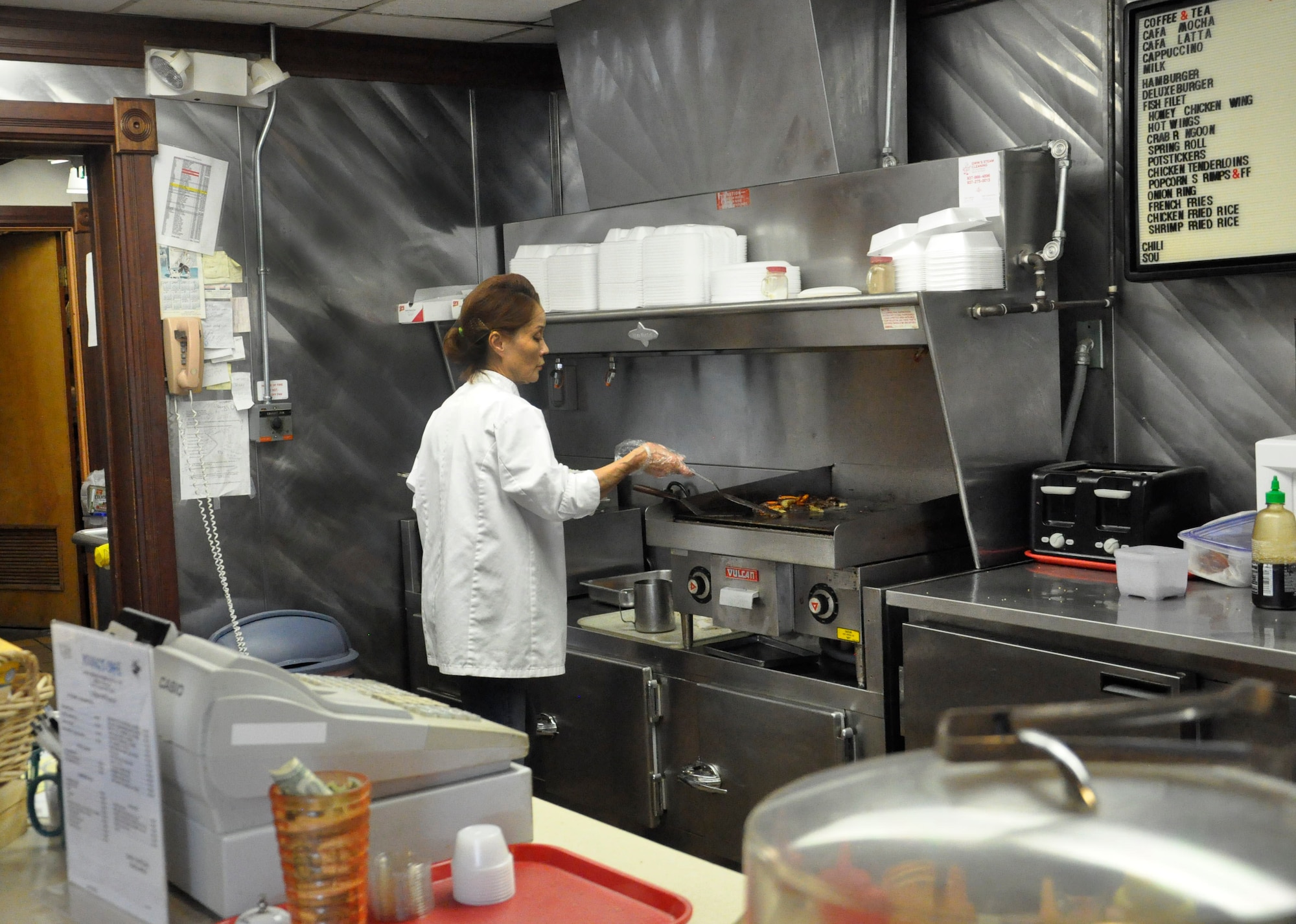 Ms. Young, owner of Young’s Café, prepares bulgogi, also known as Korean BBQ, for a customer at her restaurant inside Bldg. 22 on Area A of Wright-Patterson Air Force Base. Young’s Café is open 7 a.m.-2 p.m., offering a menu of Asian and American cuisine. (U.S. Air Force photo/Karina Brady)