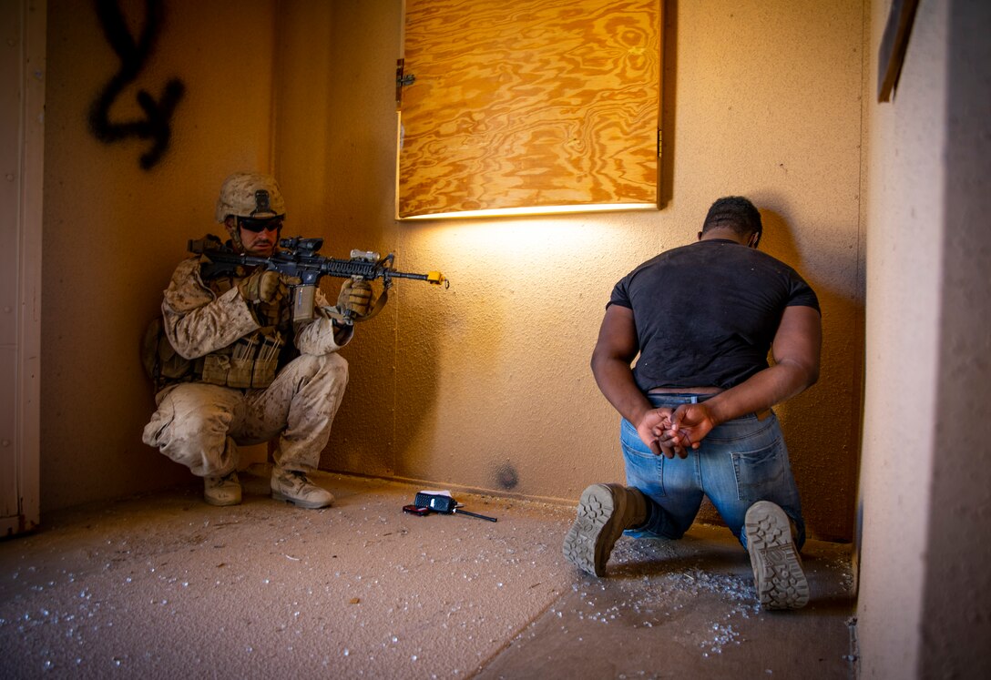 U.S. Marine Corps Sgt. Greg Whittaker, a rifleman with 1st Battalion, 25th Marine Regiment, 4th Marine Division, provides security for a detainee at Marine Corps Air Ground Combat Center Twentynine Palms, Calif., July 30, 2019, during Integrated Training Exercise 5-19. ITX 5-19 is an essential component of the Marine Forces Reserve training and readiness cycle. It serves as the principle exercise for assessing a unit’s capabilities. (U.S. Marine Corps photo by Sgt. Andy O. Martinez)