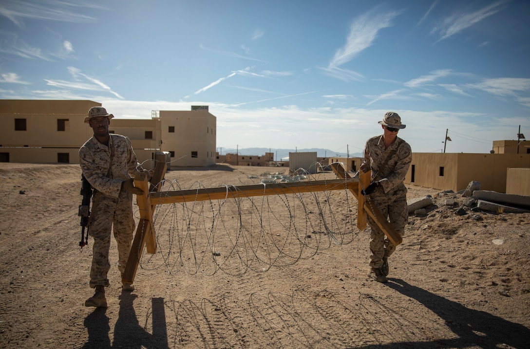 Two U.S. Marines with 1st Battalion, 25th Marine Regiment, 4th Marine Division, set up a barbwire barricade at Marine Corps Air Ground Combat Center Twentynine Palms, Calif., July 30, 2019, during Integrated Training Exercise 5-19. ITX 5-19 is an essential component of the Marine Forces Reserve training and readiness cycle. It serves as the principle exercise for assessing a unit’s capabilities. (U.S. Marine Corps photo by Sgt. Andy O. Martinez)