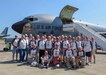 Group of Vietnam veterans pose for a photo in front of a KC-135 aircraft.