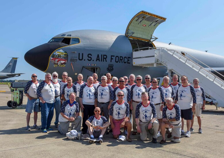 Group of Vietnam veterans pose for a photo in front of a KC-135 aircraft.