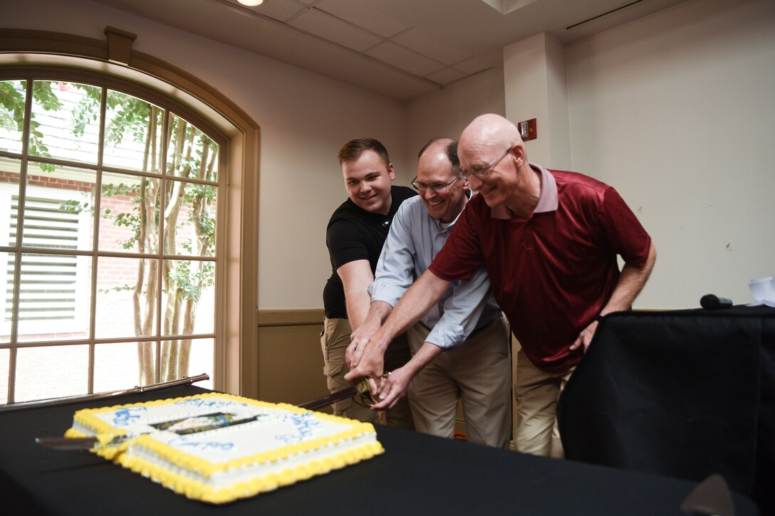 Event attendees cut a cake during the 244th Chaplain Corps Anniversary celebration event in Williamsburg, Virginia, July 26, 2019.