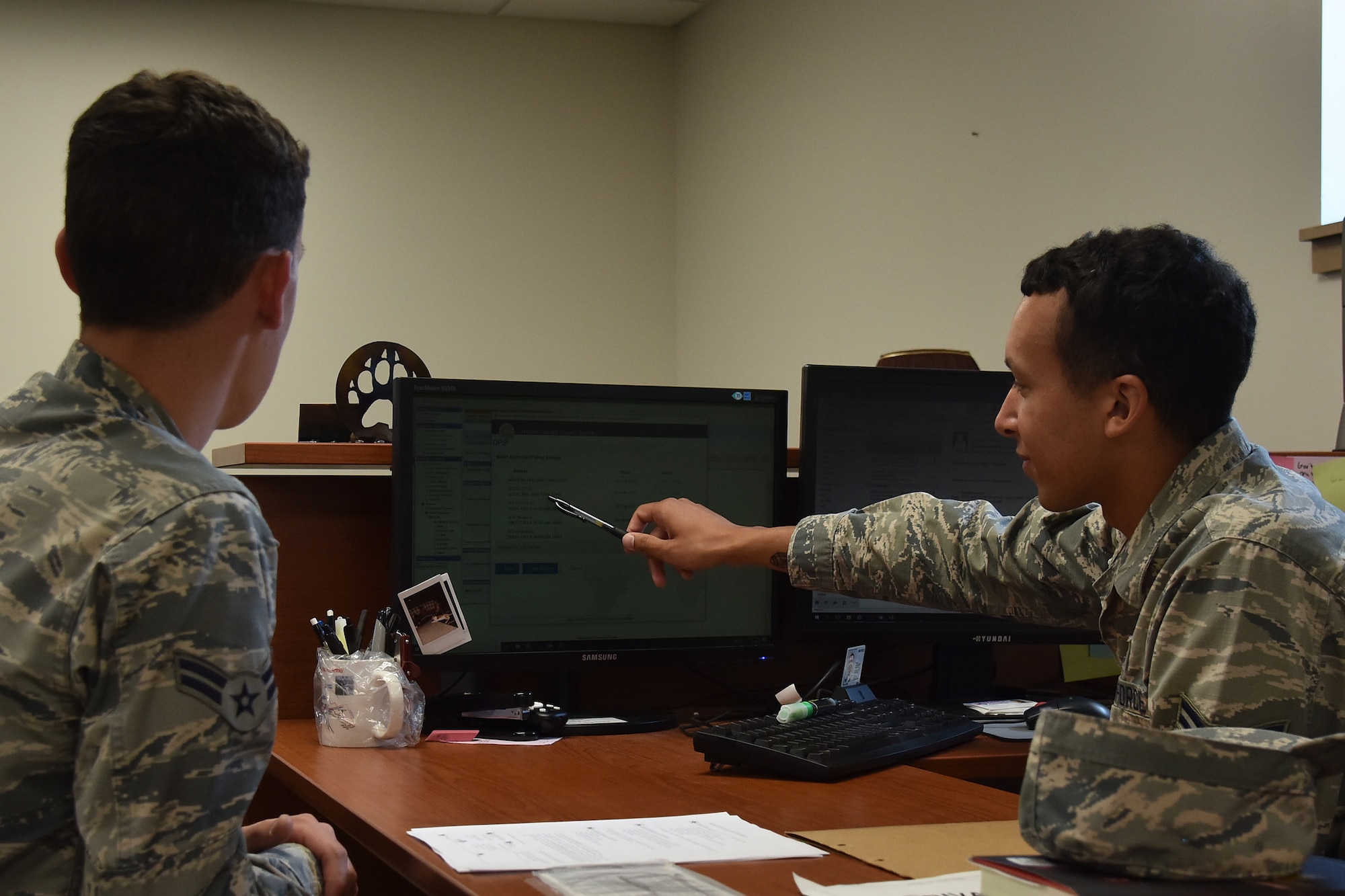 Airman 1st Class Lejavin Pulliam, 341st Logistics Readiness Squadron personal property counselor, helps a customer with move.mil July 29, 2019, at Malmstrom Air Force Base, Mont. traffic management office.