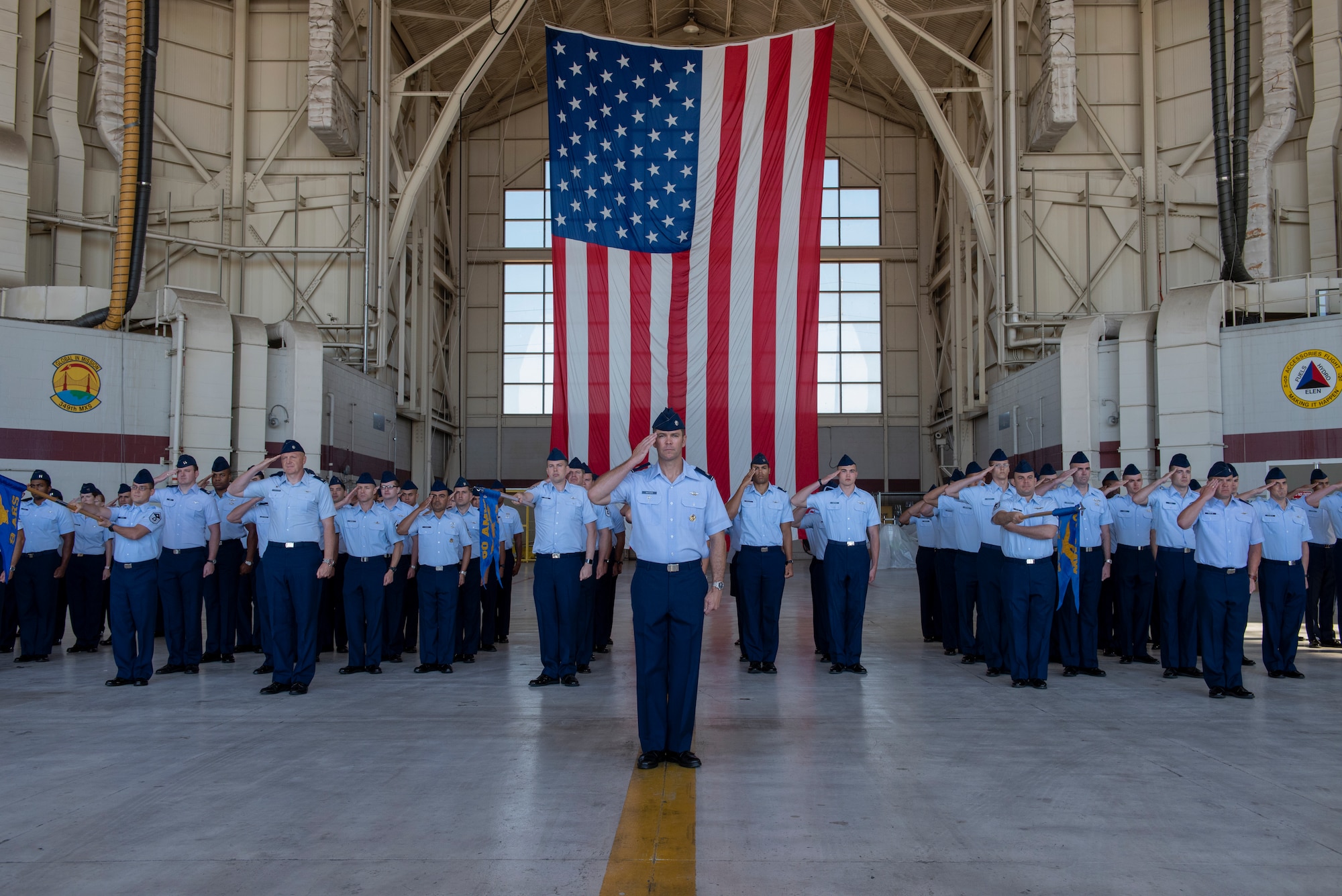 U.S. Air Force Airmen assigned to the 60th Operations Group give their final salute to Col. Theresa Weems, outgoing 60th OG commander, July 26, 2019, at Travis Air Force Base, California. Weems transferred command to Col. Gregg Johnson during a change of command ceremony. (U.S. Air Force photo by Tech. Sgt. James Hodgman)