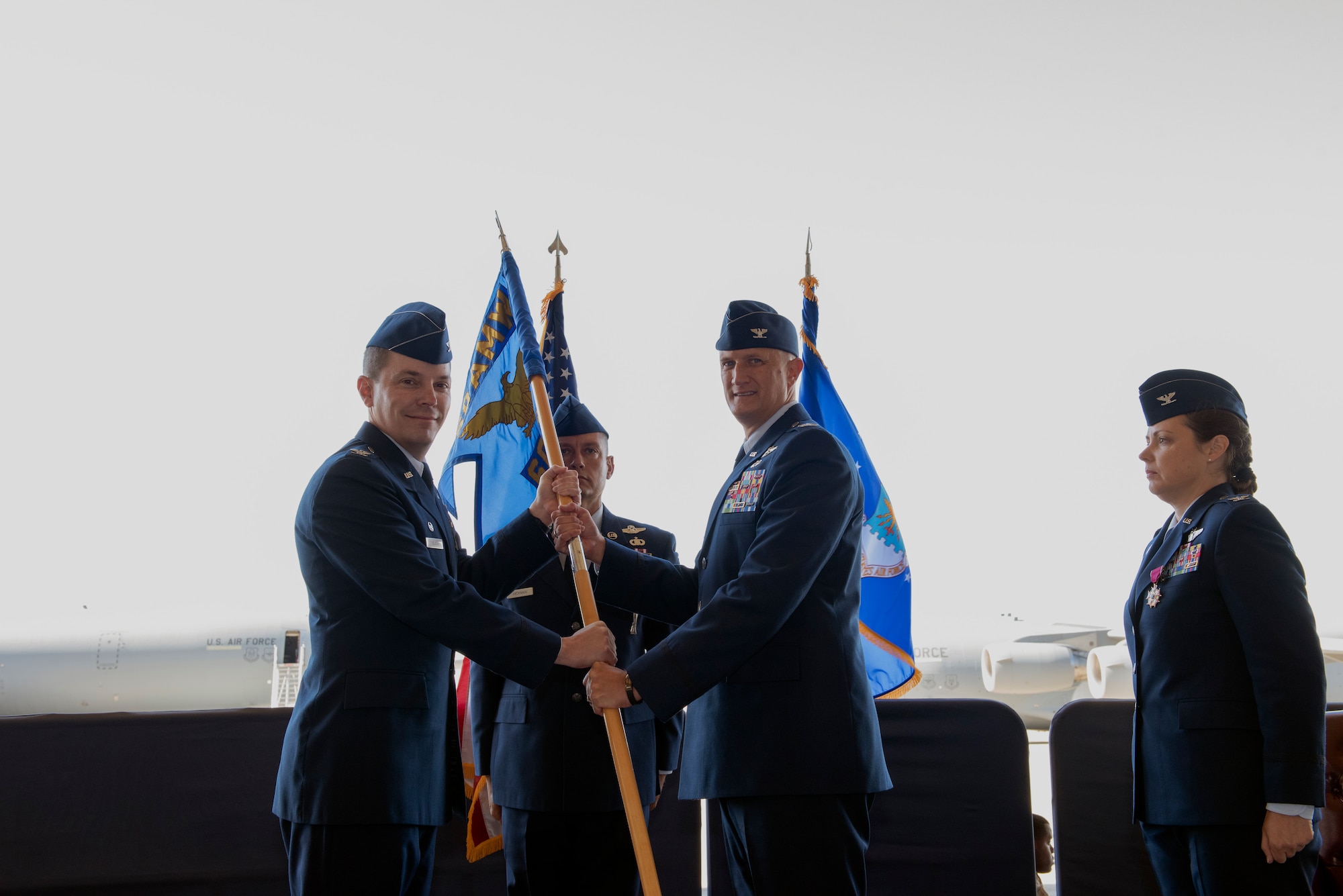 U.S. Air Force Col. Jeff Nelson, left, 60th Air Mobility Wing commander, presents the 60th Operations Group guidon to Col. Gregg Johnson, 60th OG commander, July 26, 2019, during a change of command ceremony at Travis Air Force Base, California. Johnson assumed command from Col. Theresa Weems, outgoing 60th OG commander. (U.S. Air Force photo by Tech. Sgt. James Hodgman)