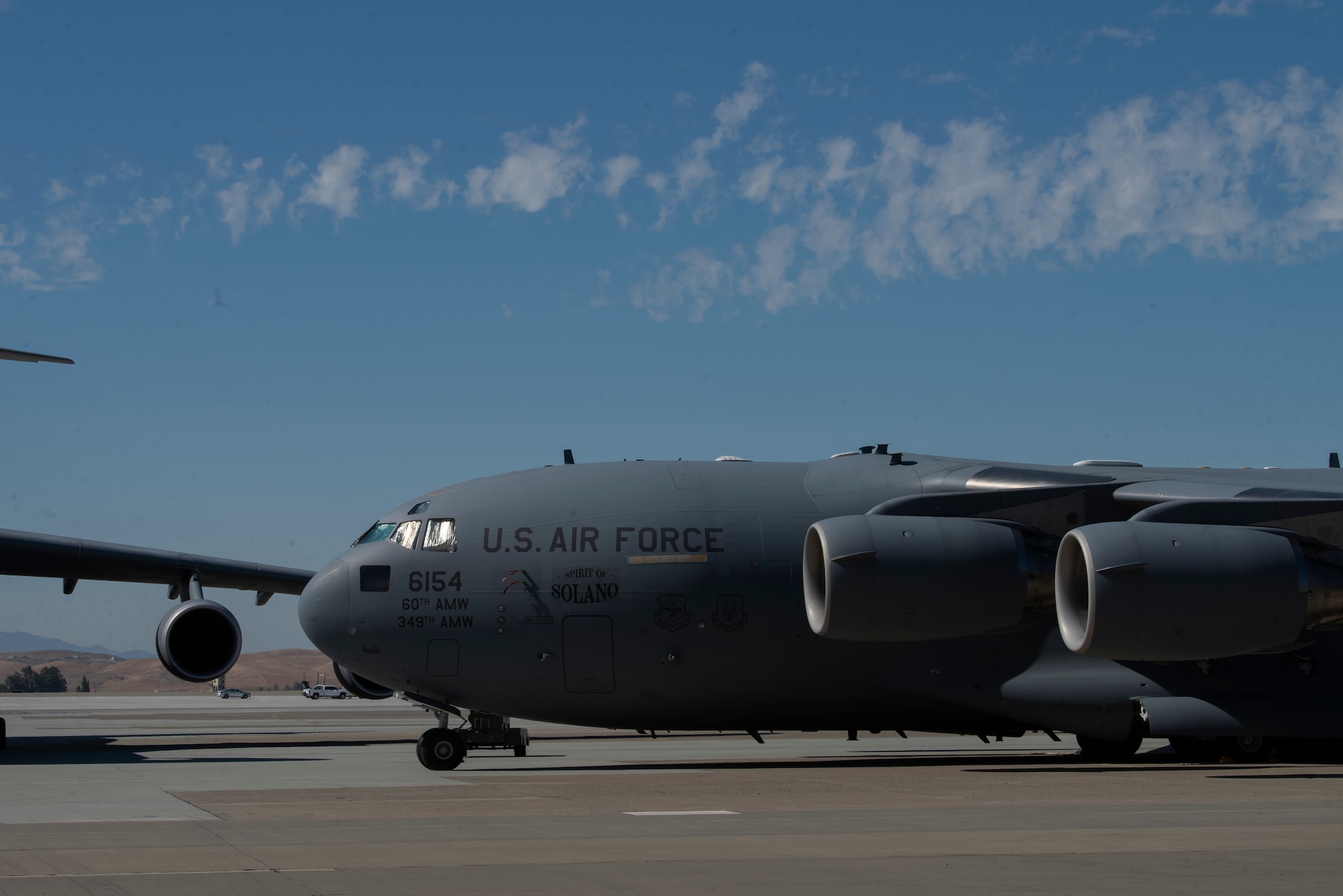 A C-17 Globemaster III is part of a static display for the 60th Operations Group change of command ceremony July 26, 2019, at Travis Air Force Base, California. The C-17 was joined in the display by a KC-10 Extender and C-5M Super Galaxy. During the ceremony, U.S. Air Force Col. Theresa Weems, outgoing 60th OG commander, transferred command to Col. Gregg Johnson. (U.S. Air Force photo by Tech. Sgt. James Hodgman)