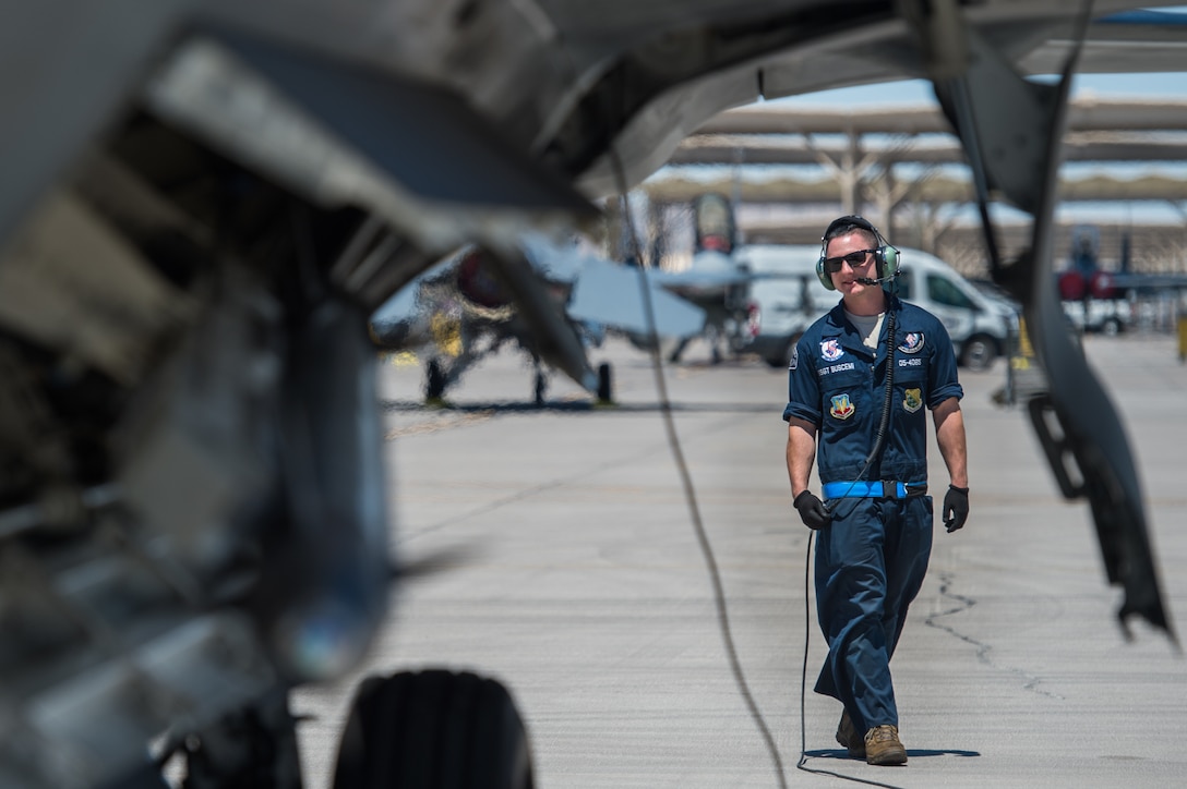 U.S. Air Force Staff Sgt. Lenny Buscemi, 94th Aircraft Maintenance Unit dedicated crew chief, runs an operations check before takeoff at Nellis Air Force Base, Nevada, July 18, 2019.