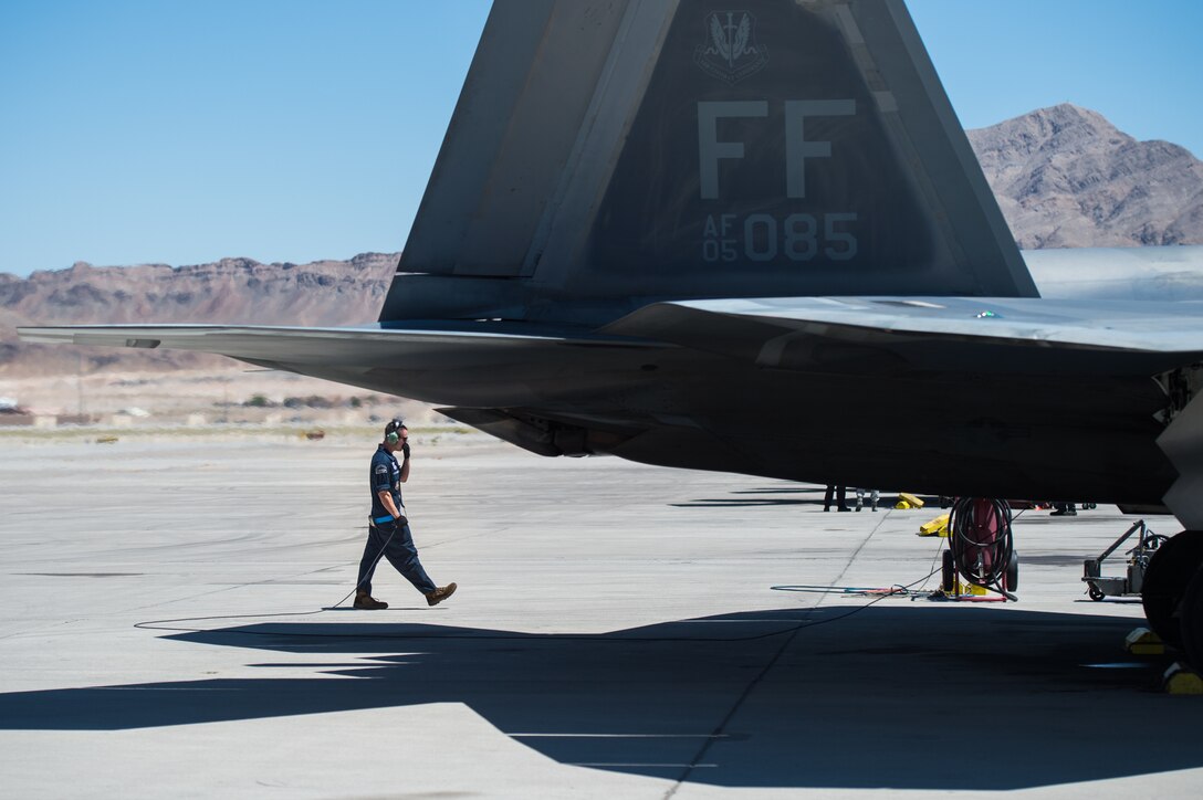 U.S. Air Force Staff Sgt. Lenny Buscemi, 94th Aircraft Maintenance Unit dedicated crew chief, runs an operations check before takeoff at Nellis Air Force Base, Nevada, July 18, 2019.