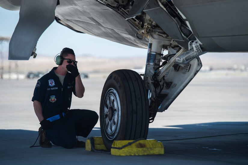 U.S. Air Force Staff Sgt. Lenny Buscemi, 94th Aircraft Maintenance Unit dedicated crew chief, runs an operations check before takeoff at Nellis Air Force Base, Nevada, July 18, 2019.